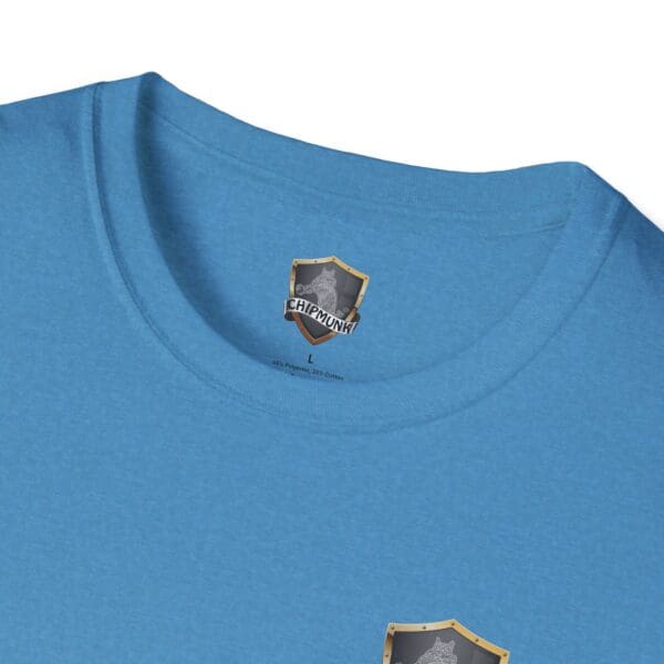 Close-up of a blue Kick Me T-Shirt featuring a printed label and a small emblem near the collar.