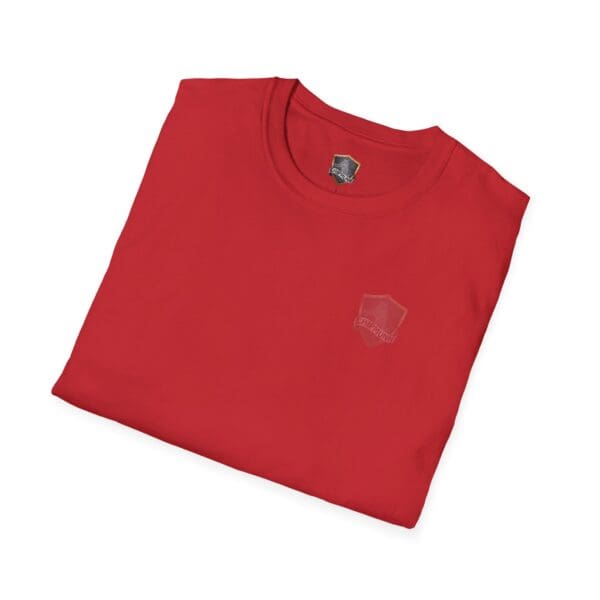 A neatly folded "You Bought It Because We Brought It" T-shirt in red, featuring a small, subtle emblem on the chest.