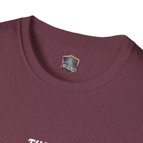 Close-up of the neckline of The Man T-Shirt in maroon, showcasing a label with a shield design and the word "Chipmunk".