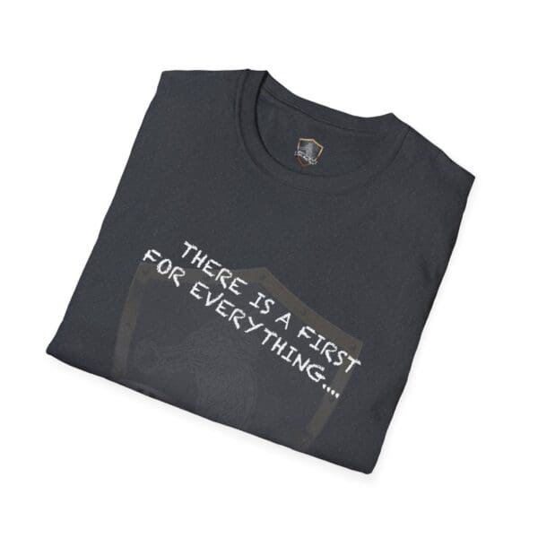 A folded dark t-shirt showcasing the text "THERE IS A FIST FOR EVERYTHING..." in white lettering, with a subtle shield design in the background. Product: There's a First for Everything... Except Impressions! T-Shirt.