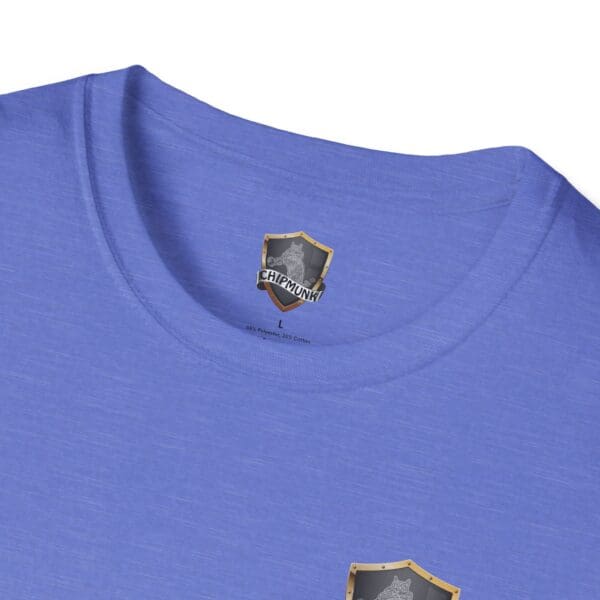 Close-up of a blue Kick Me T-Shirt featuring a "Chipmunk" shield logo.