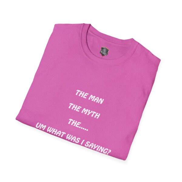 A folded pink T-shirt displaying white text that reads "The Man, The Myth, The... Um What Was I Saying?" from the collection of "The Man T-Shirt.