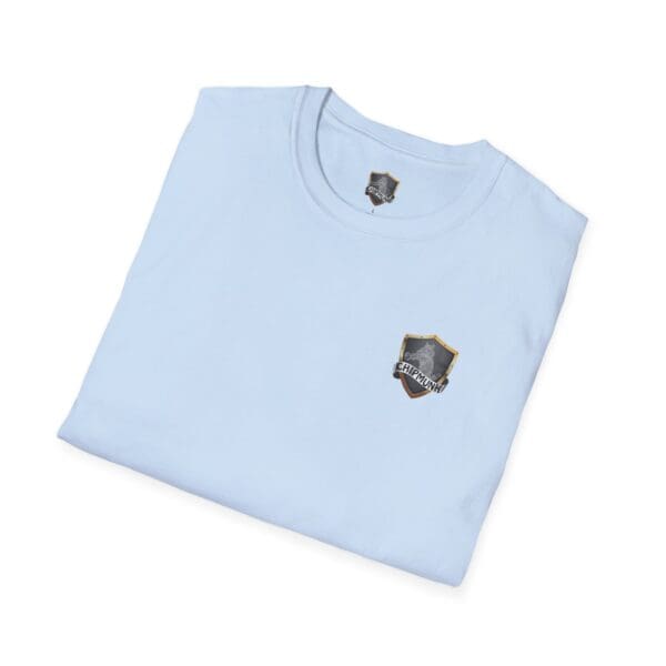 A folded Vacation T-Shirt in light blue with a shield logo on the chest.