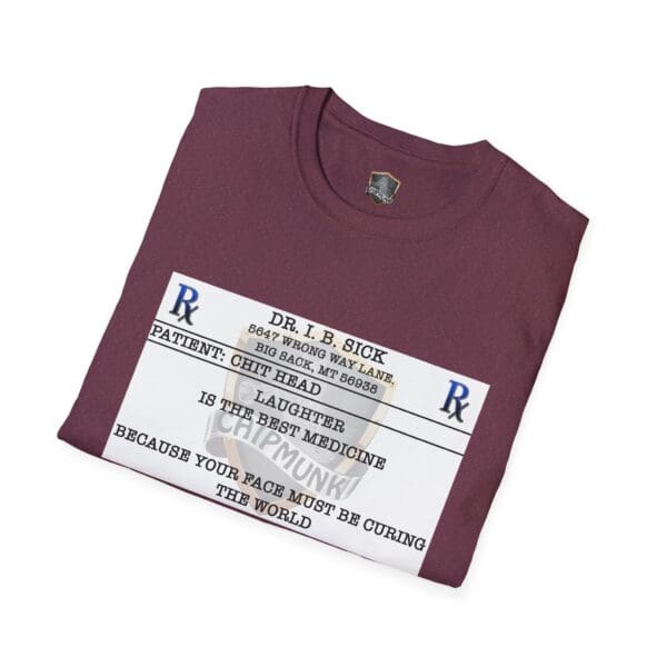 A folded Laughter T-Shirt in maroon features a humorous prescription label design with a mock prescription from "Dr. I. B. Sick," recommending laughter as the best medicine.