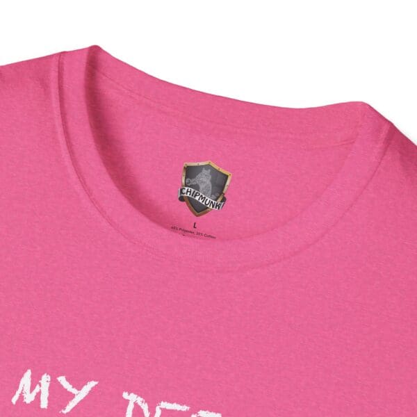 Close-up of a pink "Unsupervised Mischief" T-shirt with a "Chipmunk" logo label inside the collar. White text partially visible at the bottom.