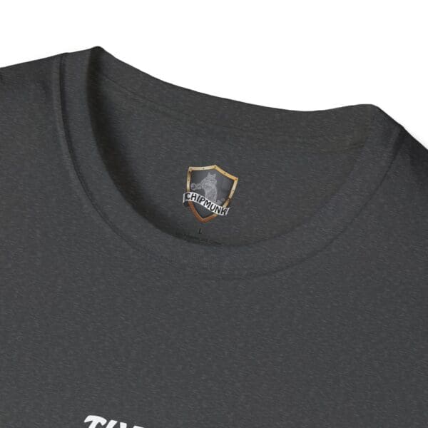 Close-up of a dark gray "The Man T-Shirt" showcasing a Chipmunk logo on the inside of the collar.