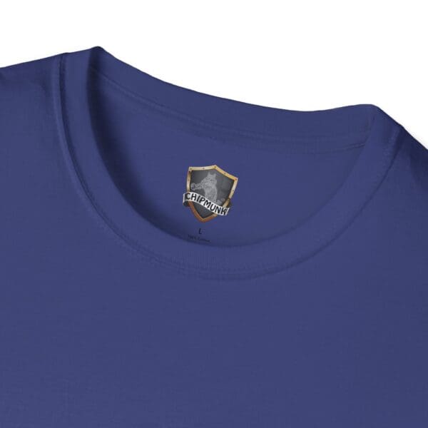 Close-up of a blue Douche Canoe T-Shirt featuring a label with a shield logo and the word "Chipmunk.