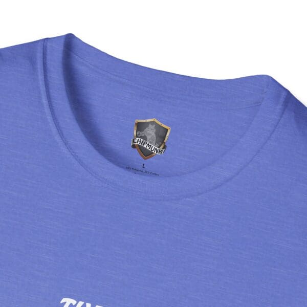 Close-up of The Man T-Shirt in blue featuring a "Chipmunk" logo and size label (L) near the collar.