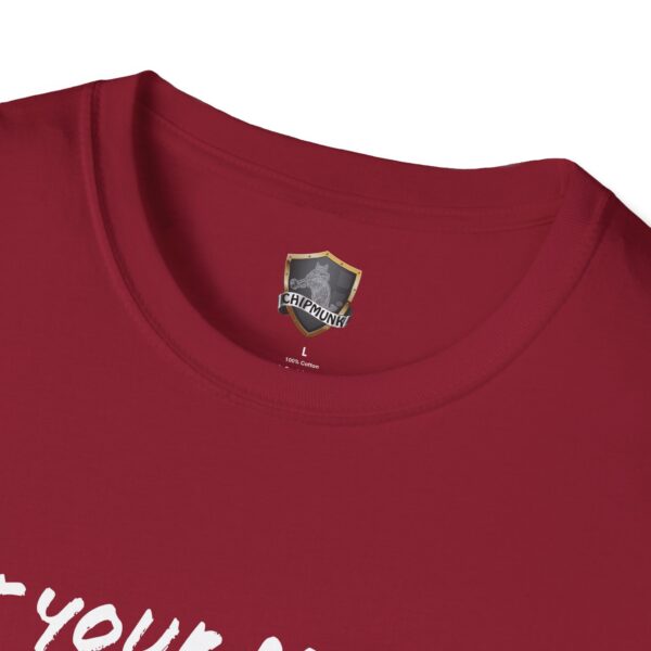 Close-up of a red Lunchbox Logic Tee's collar featuring a "Chipmunk" label inside, showing it's 100% cotton and size L. A hint of white text is partially visible on the shirt.