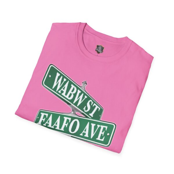 A folded Street Sign T-Shirt in pink features a graphic of intersecting green street signs labeled "WABW ST" and "FAAFO AVE.